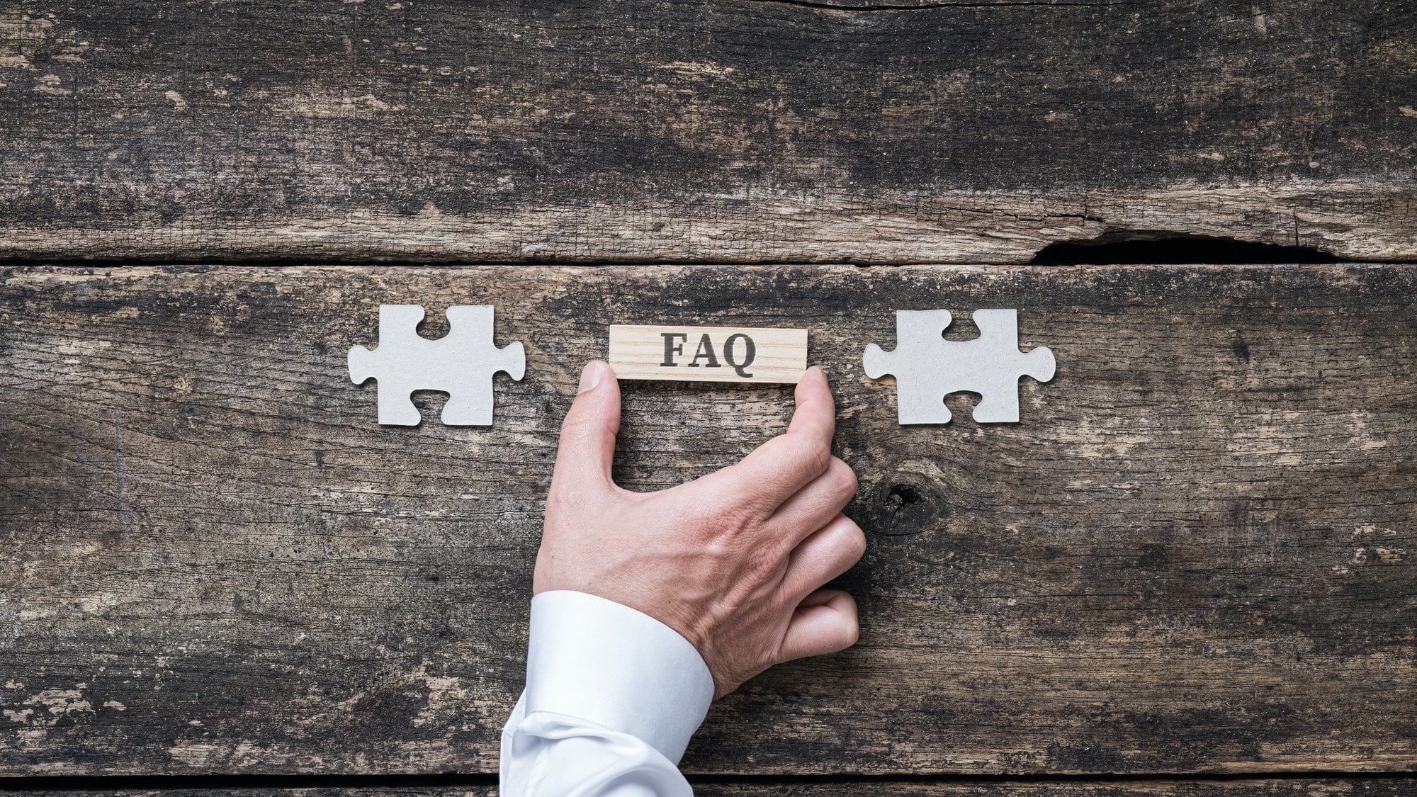 FAQ sign on wooden peg